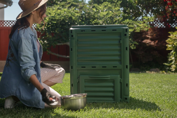 woman using ecogardener compost bin