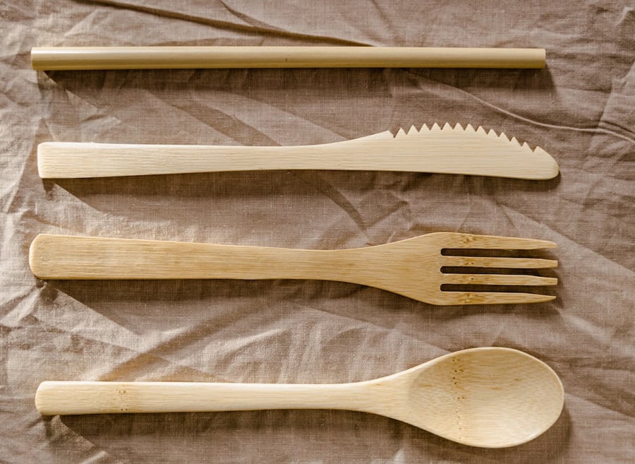 top view of wooden fork, spoon, knife and straw 