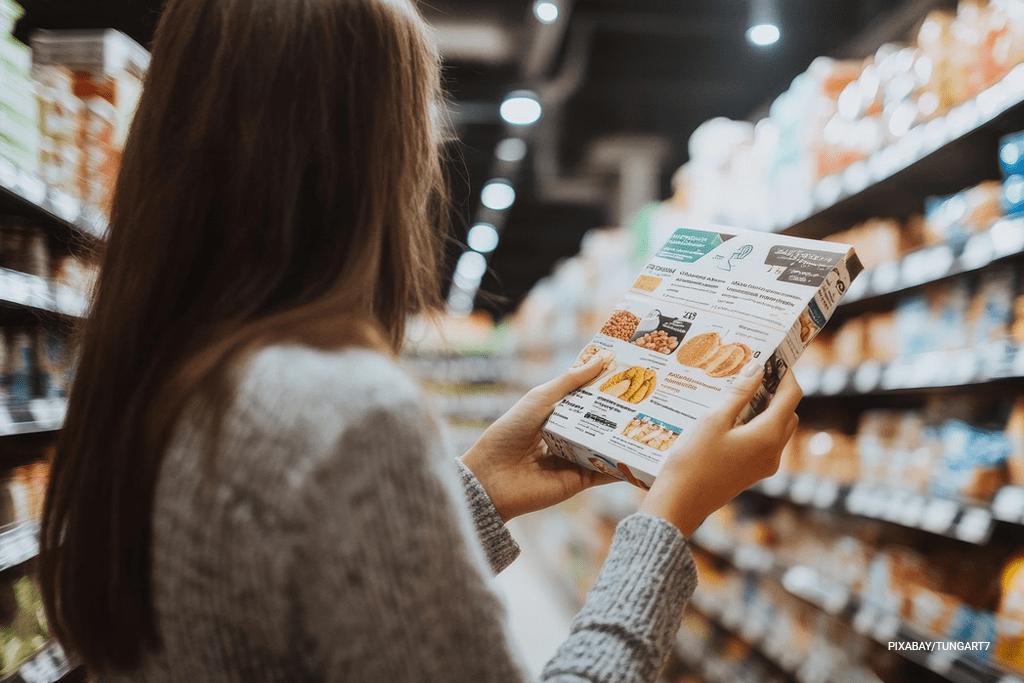 woman reading back label of food box