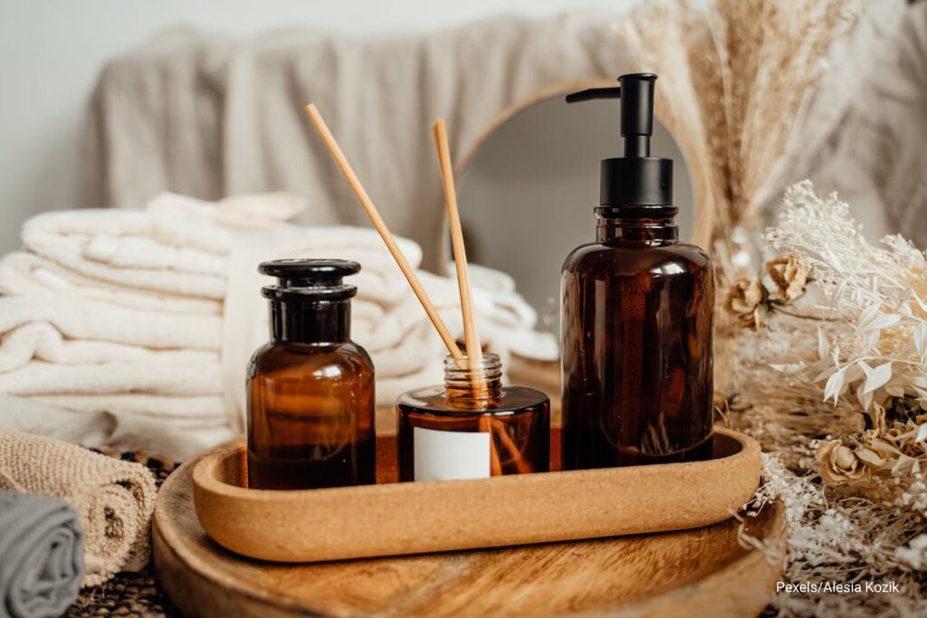 essential oil and stick inside wooden tray