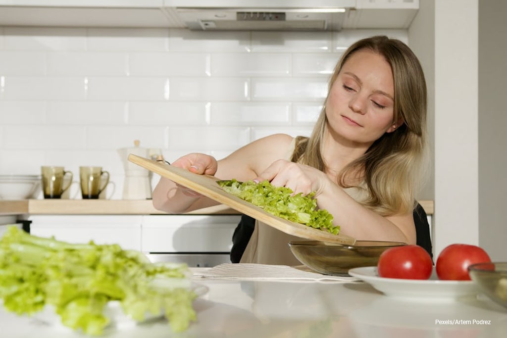 woman preparing lettuce to eat