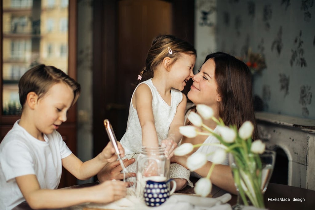mother is happily playing with his children