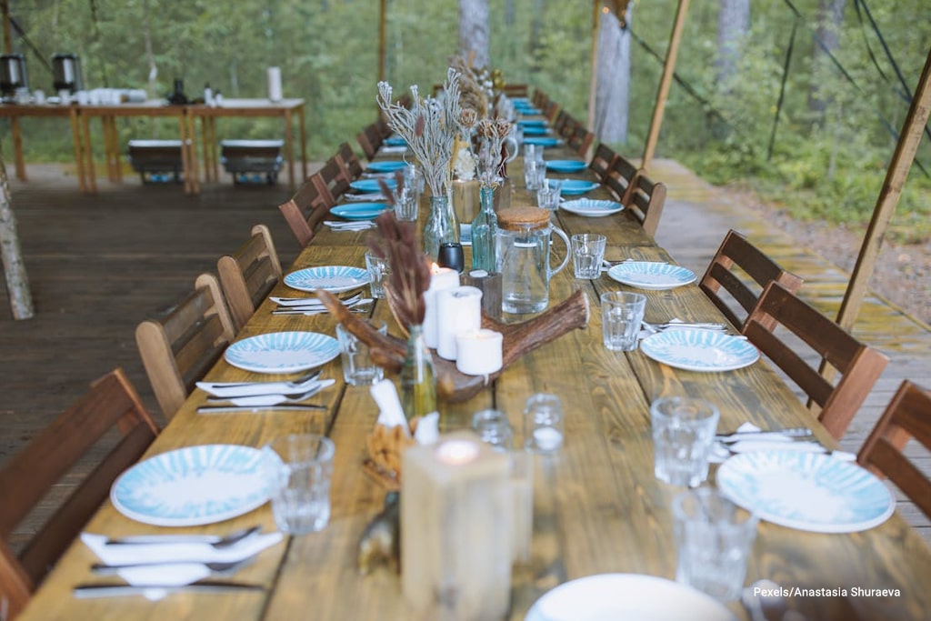 brown wooden table with chairs and plates