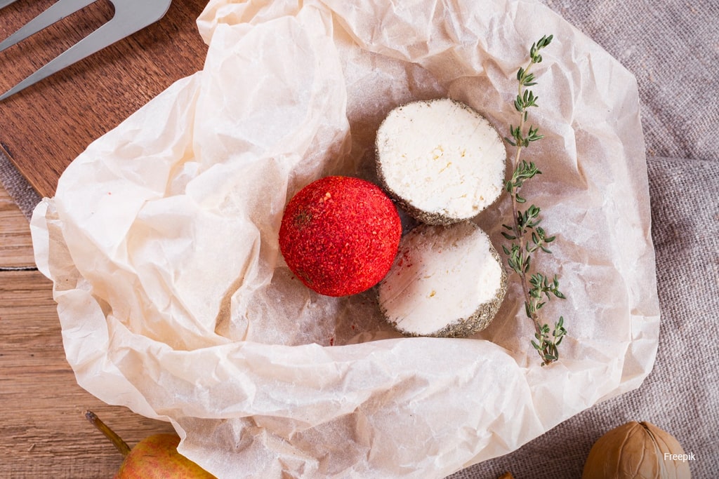 Flat lay cheese cut in half on table