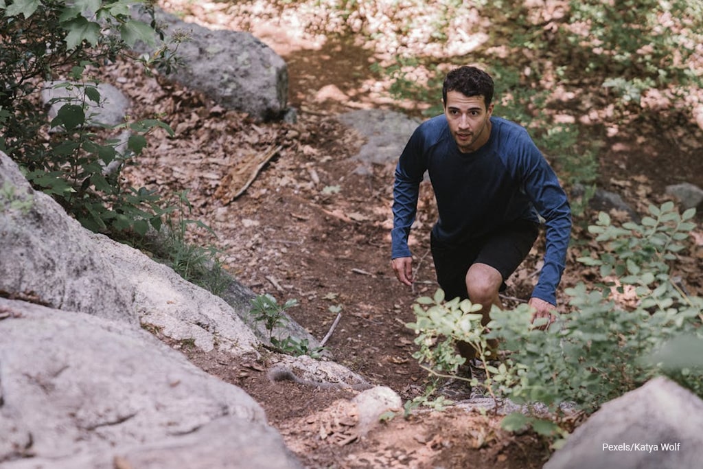 man climbing on the hill