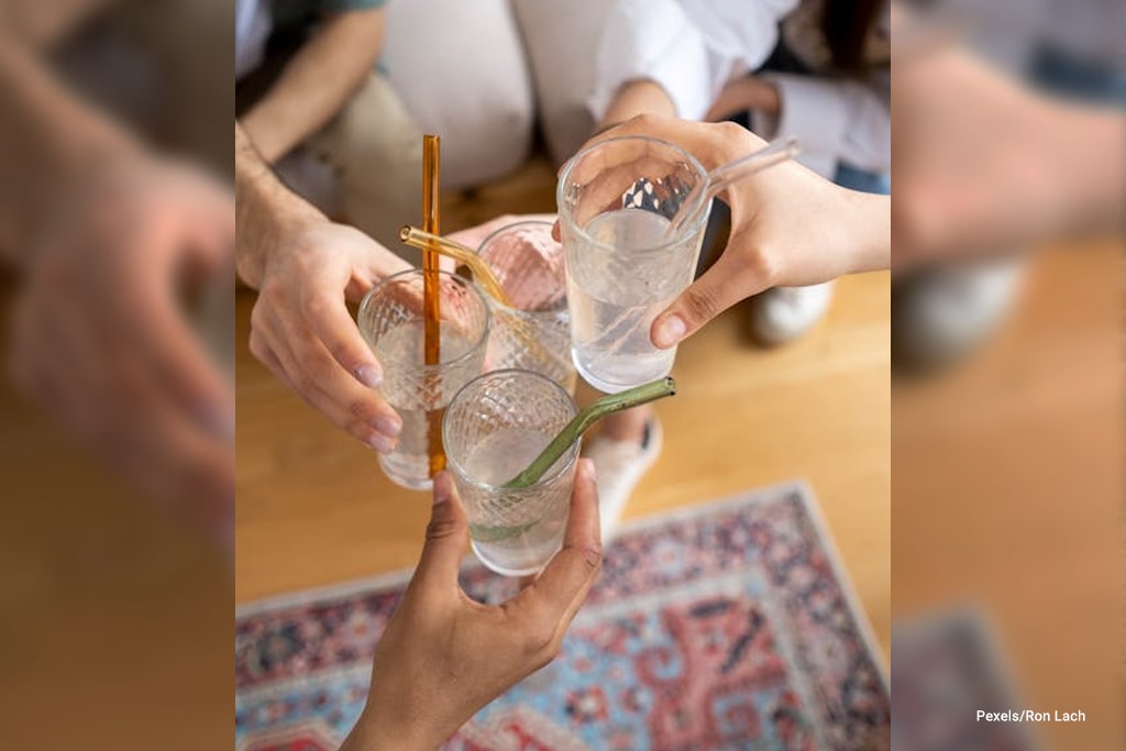 a group of people doing a toast with drinking glassses