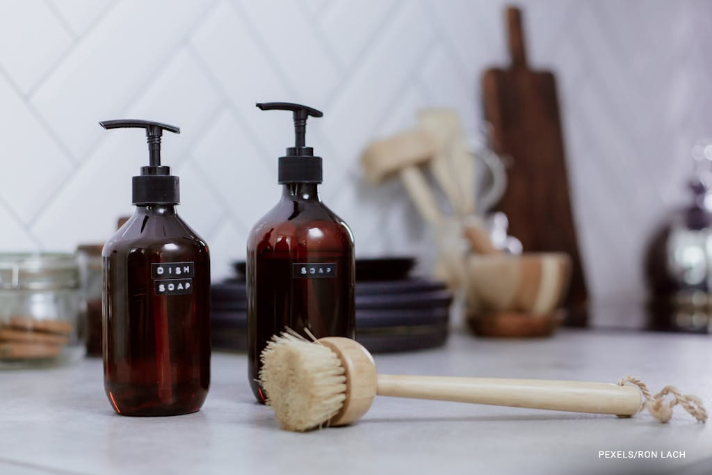 wood brush and bottle of dish soap