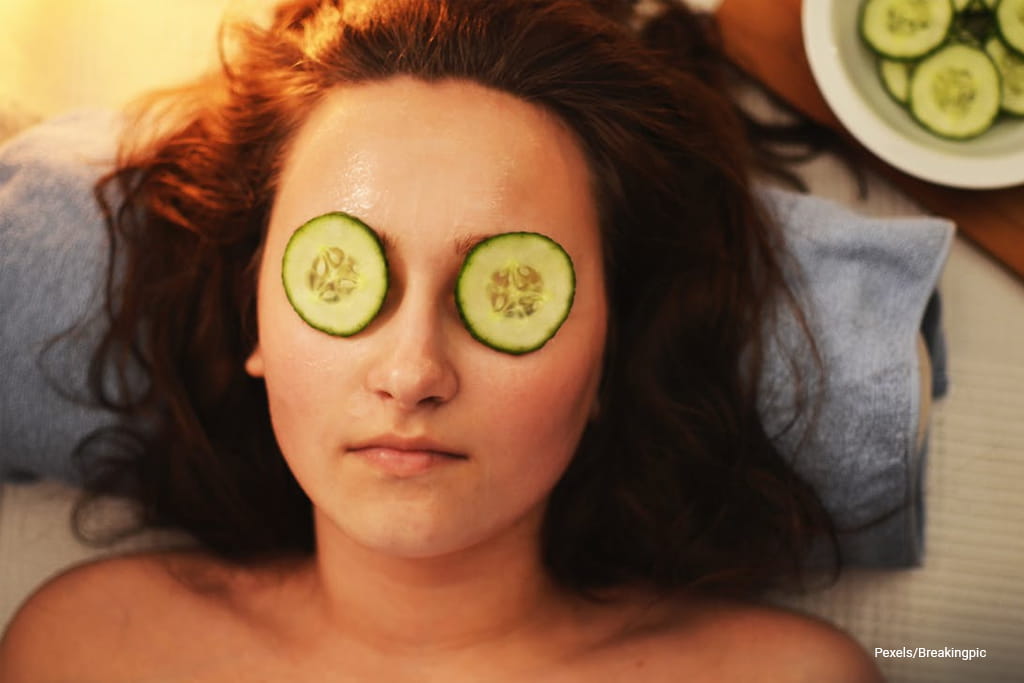 Woman put cucumber to her eyes