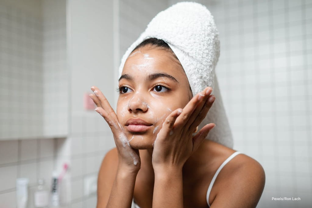 woman cleaning her face