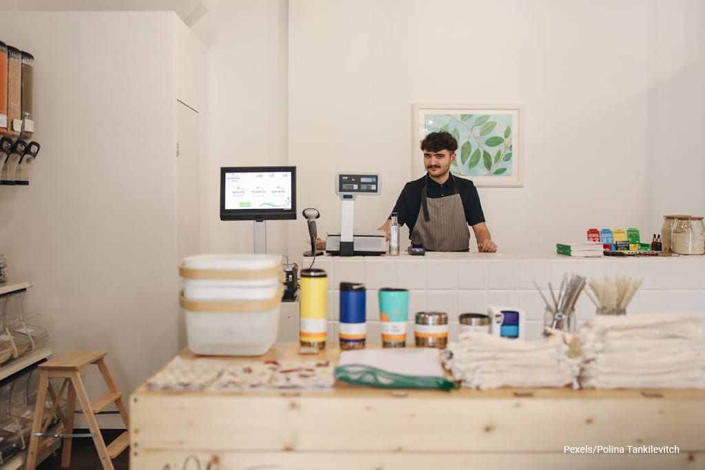 man standing at cashier drawer